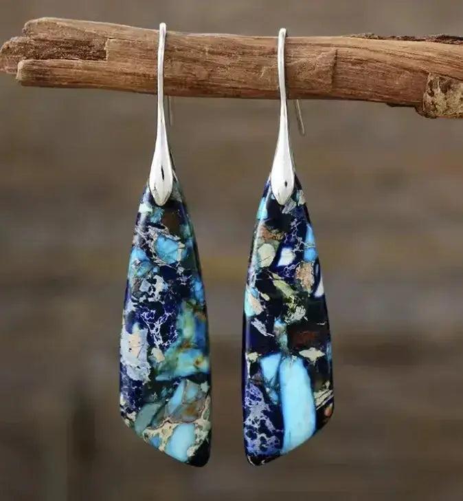 Empire Jasper Teardrop Earrings with unique blue, black, and cream patterns, set in silver boho hooks. Grounding and creative.