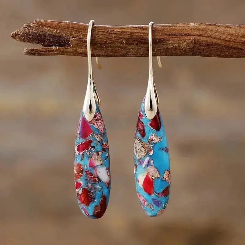 Empire Jasper Teardrop Earrings with earthy terracotta, sage, cream, and rust patterns on blue, promoting grounding.