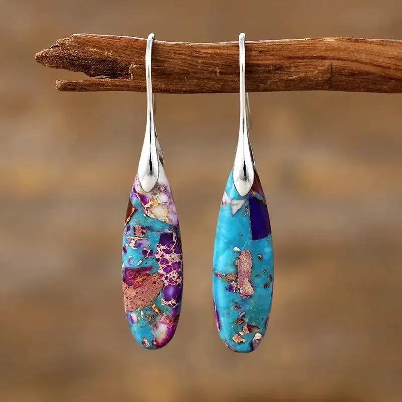 Empire Jasper Teardrop Earrings with unique swirling patterns of blue, purple, and terracotta, hung from silver boho hooks.
