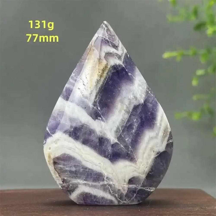 Fantasy Amethyst torch freeform with layered purple and white quartz, polished into a flame shape for calming intuition.