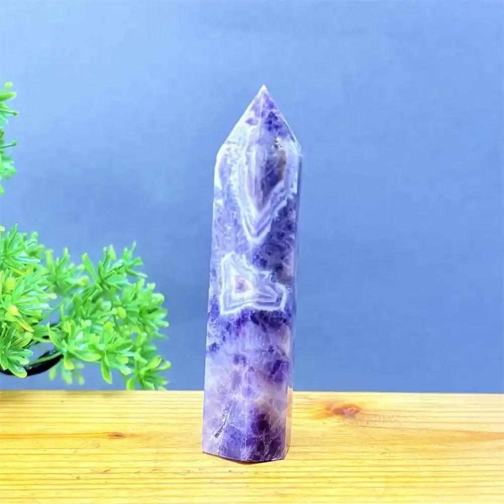 Hand-polished Fantasy Amethyst tower with purple and white quartz layers, perfect for meditation and chakra balancing.