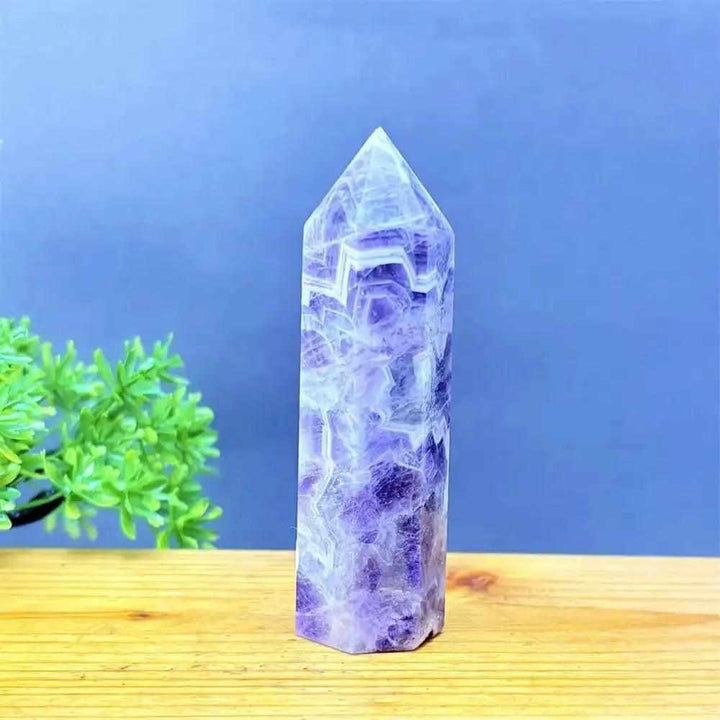 Fantasy Amethyst tower with layered purple and white quartz, featuring a faceted point for meditation and calm energy.