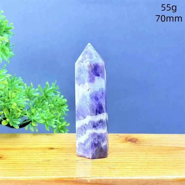 Fantasy Amethyst tower with purple and white quartz layers, a faceted point for meditation, and calming crystal energy.
