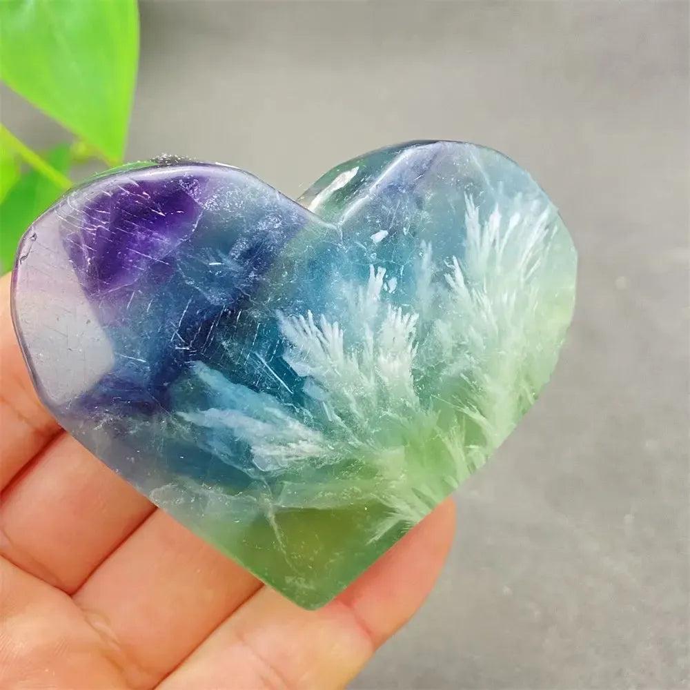 Polished Feather Fluorite crystal heart with purple, blue, green, and clear bands, featuring white feather-like inclusions.
