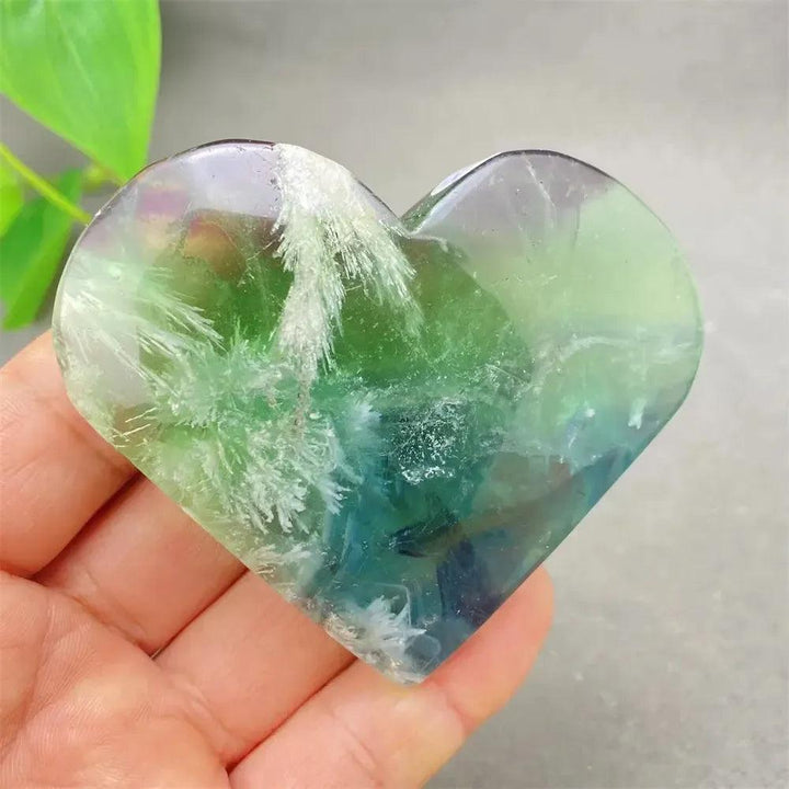 Feather Fluorite Crystal Heart: Polished heart-shaped crystal with stunning bands of purple, green, blue, and clear tones.