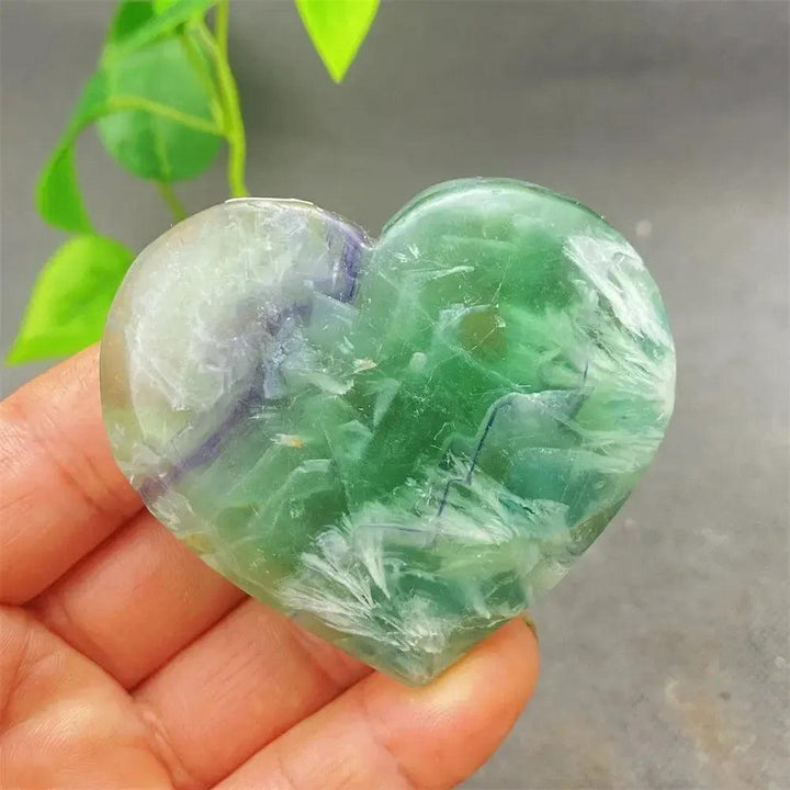 Feather Fluorite Crystal Heart: Polished green, purple, and clear fluorite heart for mental clarity and emotional balance.