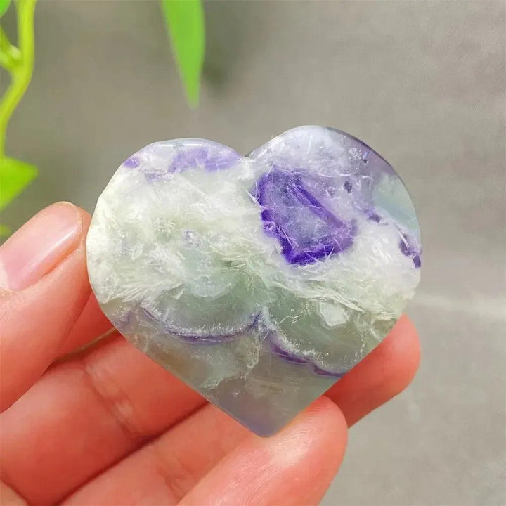 Feather Fluorite Crystal Heart: Polished purple, green, and clear fluorite heart for mental clarity and emotional balance.