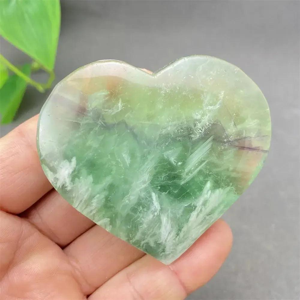 Feather Fluorite Crystal Heart: Polished green, purple, and clear fluorite heart for mental clarity and emotional balance.