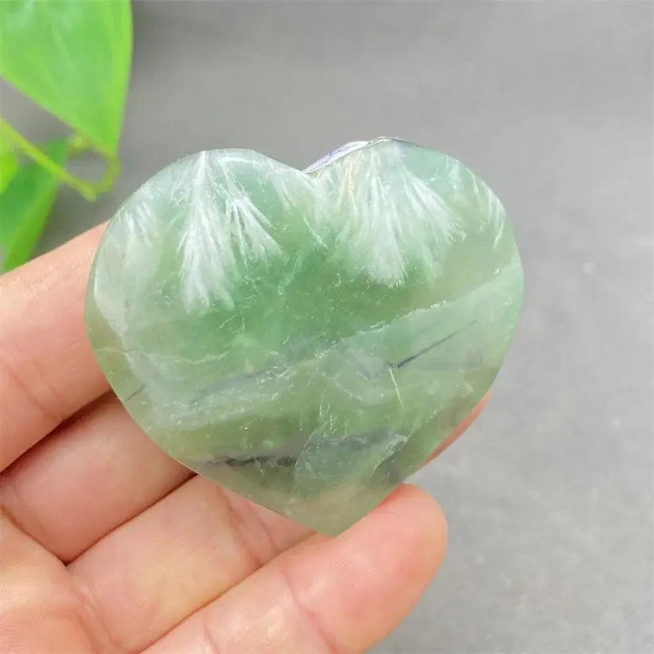 Feather Fluorite Crystal Heart: Polished green fluorite heart with white feather-like inclusions, promoting clarity and focus.