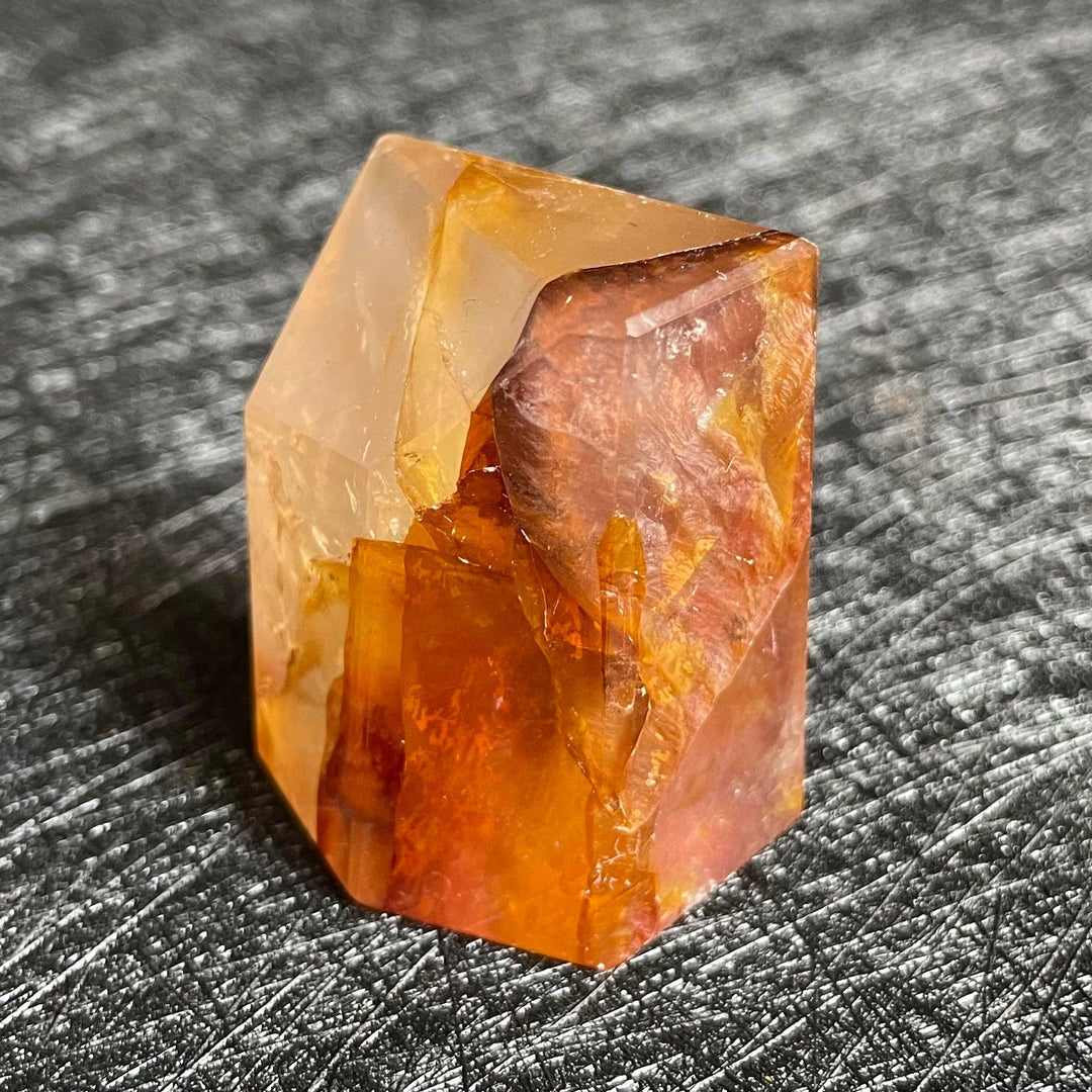 Polished Fire Quartz crystal freeform, showcasing warm iron oxide inclusions in blush, rust, and amber hues.