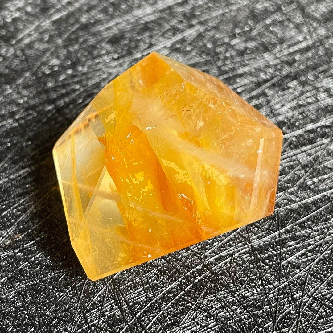 Polished Fire Quartz crystal freeform, showcasing warm orange and amber iron oxide inclusions within clear quartz.