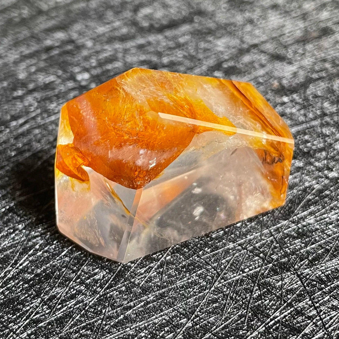 Polished Fire Quartz crystal freeform, showcasing warm orange and rust iron oxide inclusions within clear quartz.