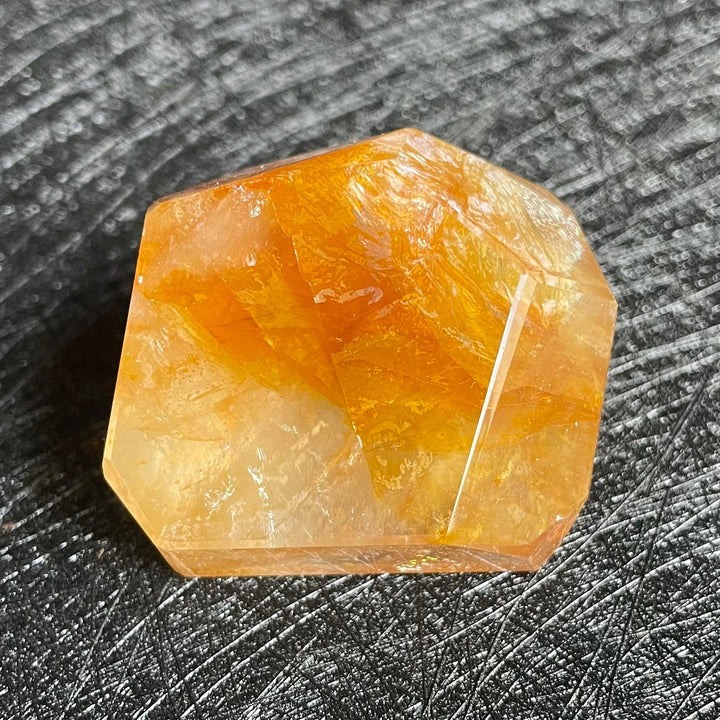 Polished Fire Quartz crystal freeform with warm orange and amber iron oxide inclusions, glowing from within.