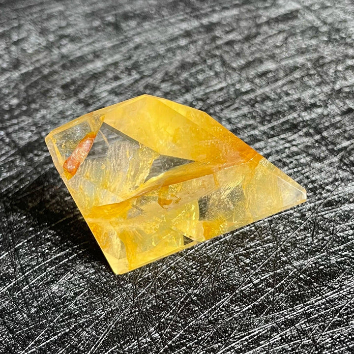 Polished Fire Quartz freeform crystal, glowing with warm yellow, orange, and rust iron oxide inclusions.
