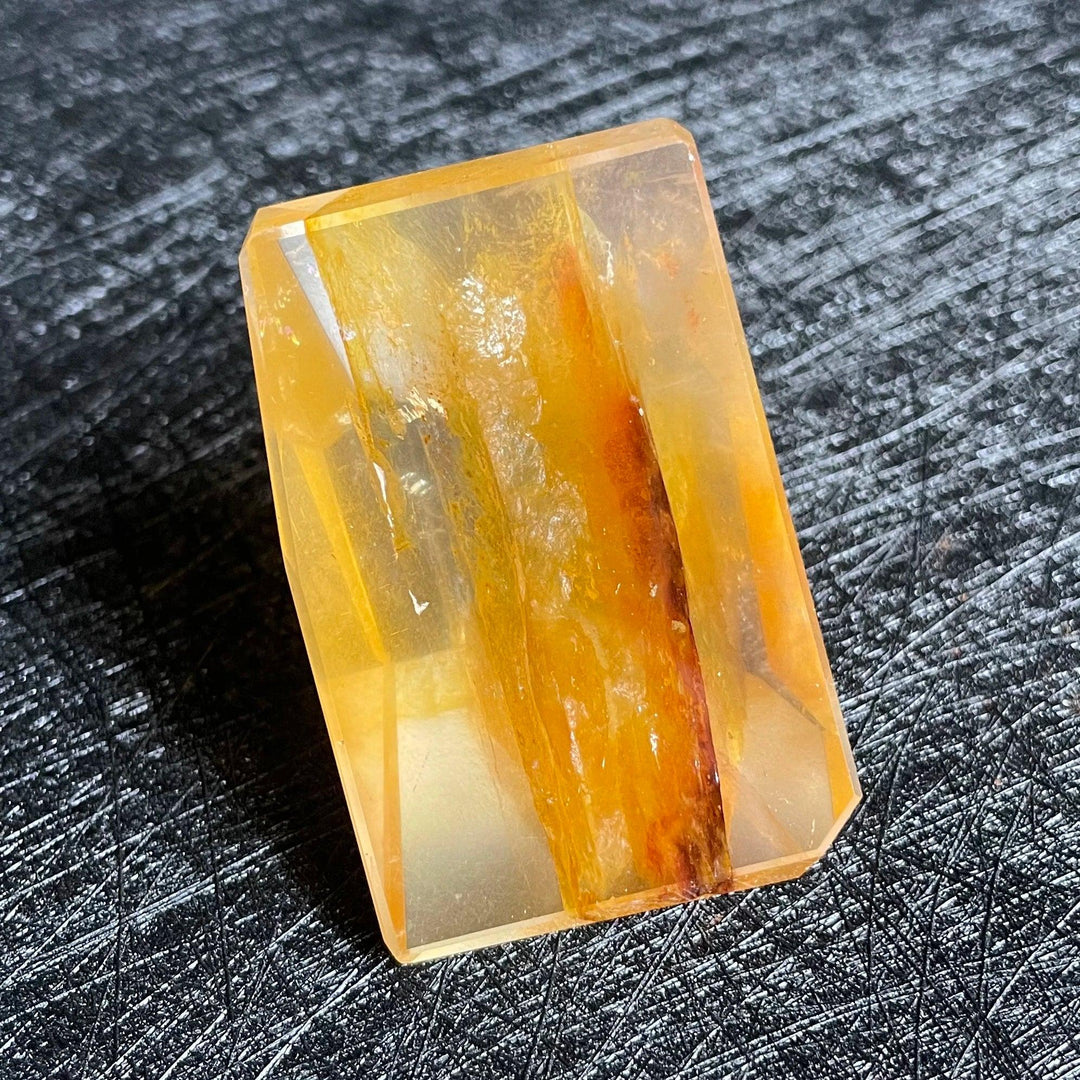 Polished Fire Quartz crystal freeform with warm amber, rust, and blush iron oxide inclusions, glowing from within.