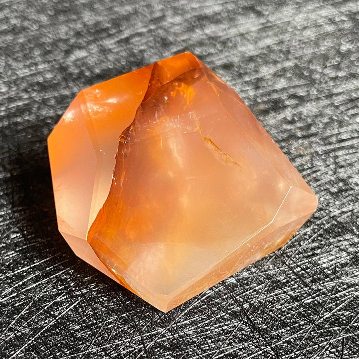 Polished Fire Quartz crystal freeform with warm blush to deep rust and amber iron oxide inclusions, glowing from within.