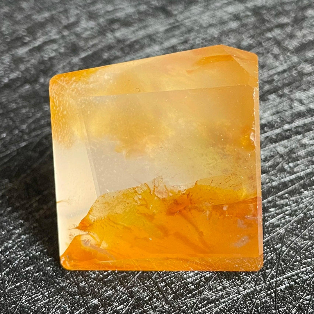 Polished Fire Quartz freeform crystal with warm orange, rust, and amber iron oxide inclusions glowing within clear quartz.
