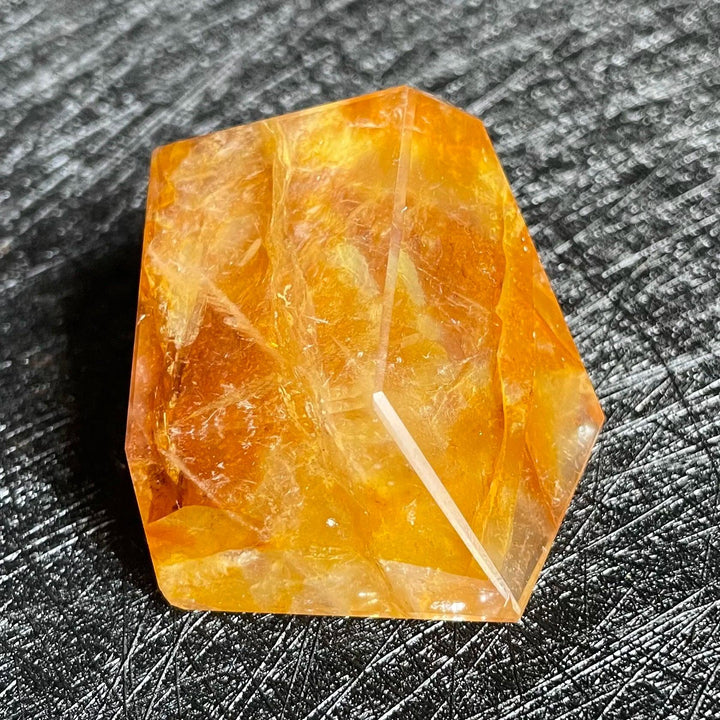 Polished Fire Quartz freeform crystal with warm amber and rust inclusions, glowing from within.