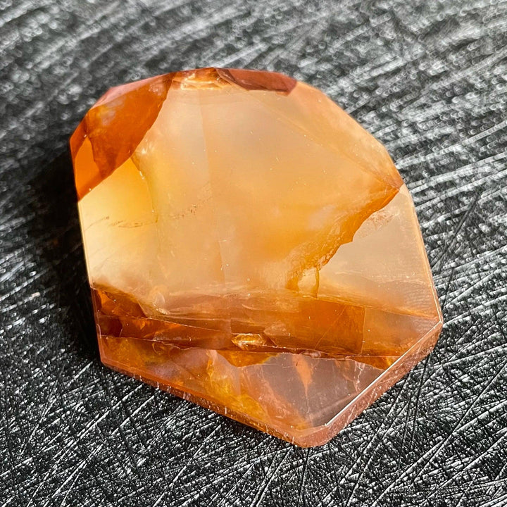 Polished Fire Quartz freeform with warm blush to deep rust and amber iron oxide inclusions, glowing from within.
