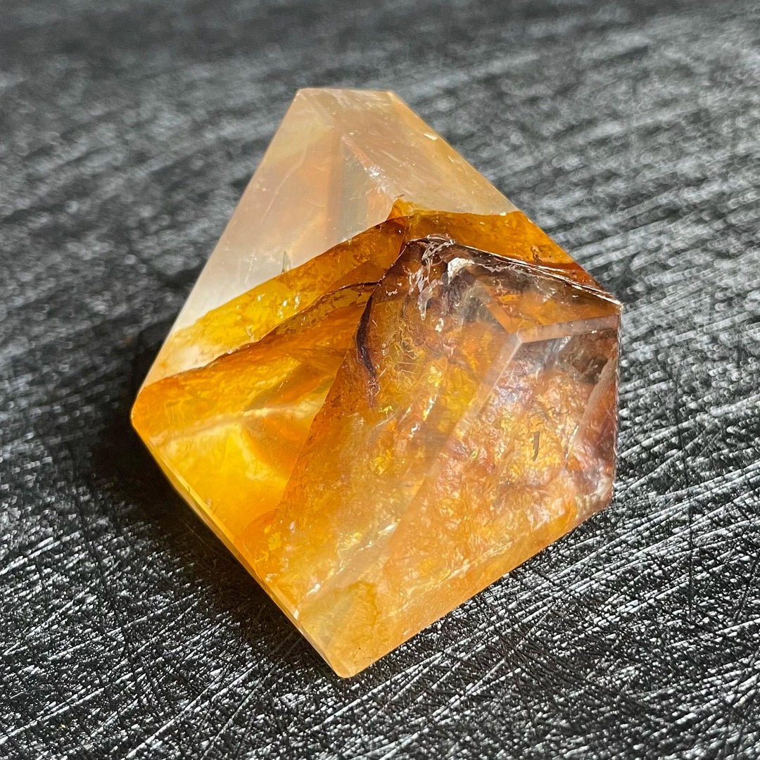 Polished Fire Quartz crystal freeform with warm amber and rust iron oxide inclusions, glowing from within.