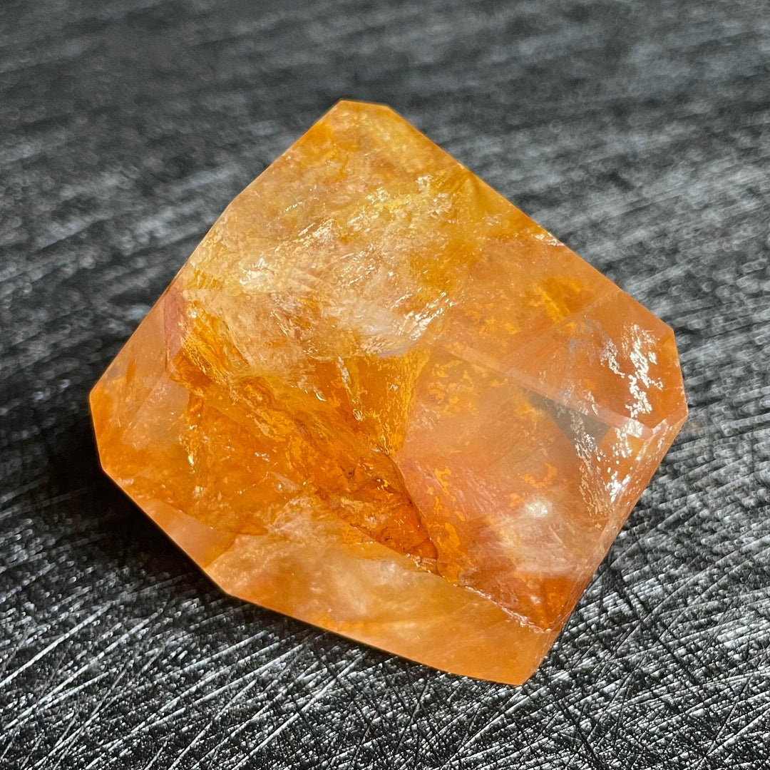 Polished Fire Quartz crystal freeform, showcasing warm orange and rust iron oxide inclusions within clear quartz.
