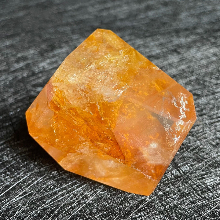 Polished Fire Quartz crystal freeform, showcasing warm orange and rust iron oxide inclusions within clear quartz.
