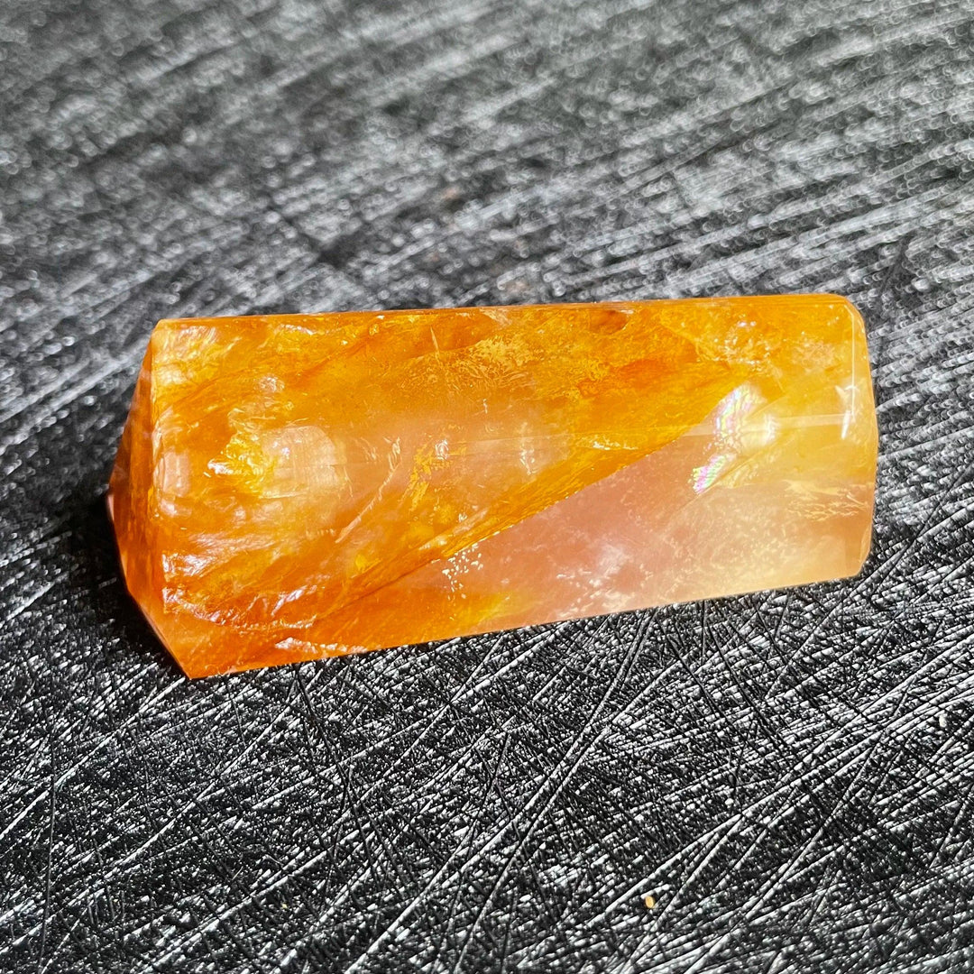 Polished Fire Quartz crystal freeform, glowing with warm orange, rust, and amber iron oxide inclusions.