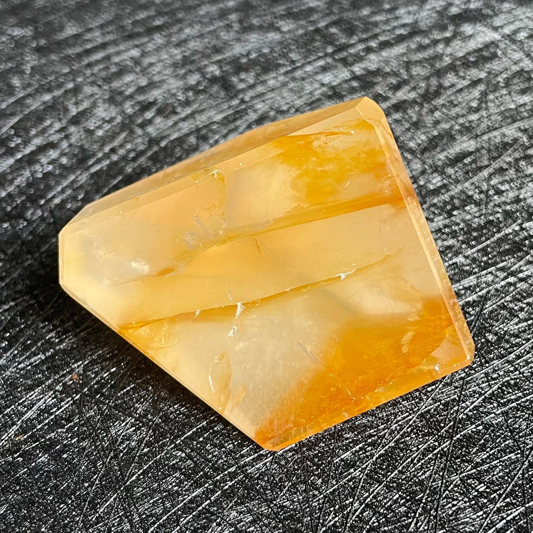 Polished Fire Quartz freeform crystal with warm orange and rust iron oxide inclusions, glowing from within.