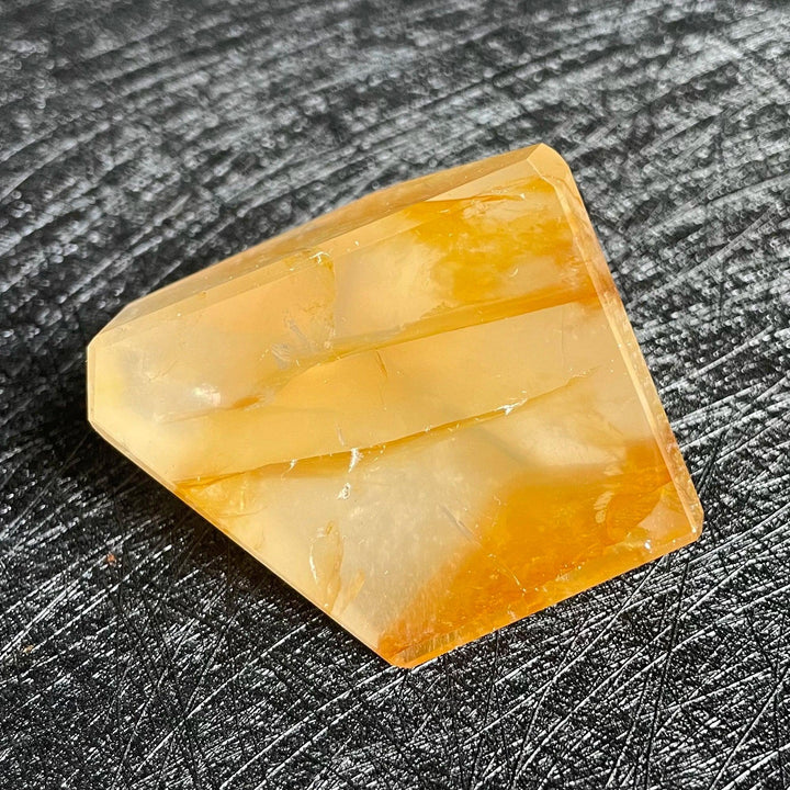 Polished Fire Quartz freeform crystal with warm orange and rust iron oxide inclusions, glowing from within.