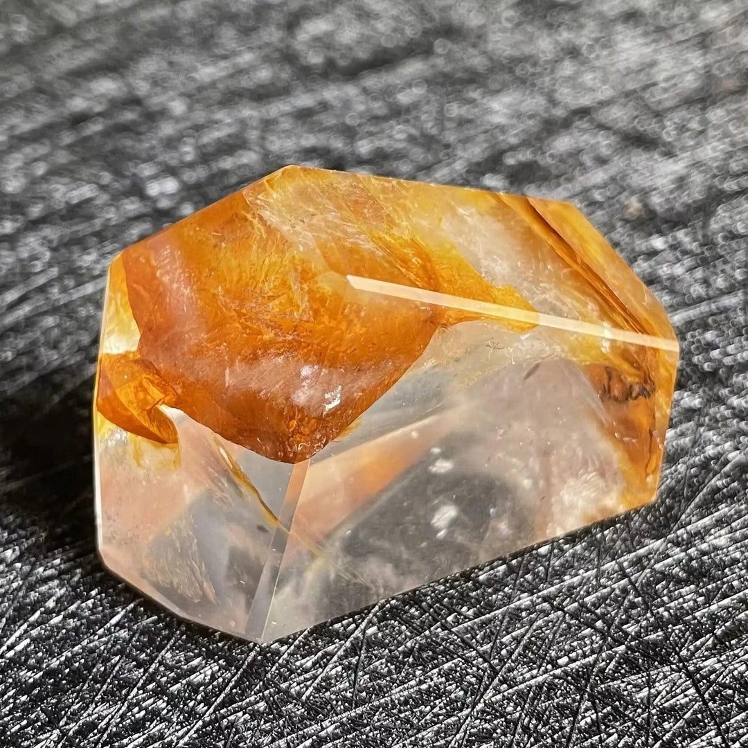 Polished Fire Quartz freeform with warm, glowing orange and rust iron oxide inclusions in clear quartz.