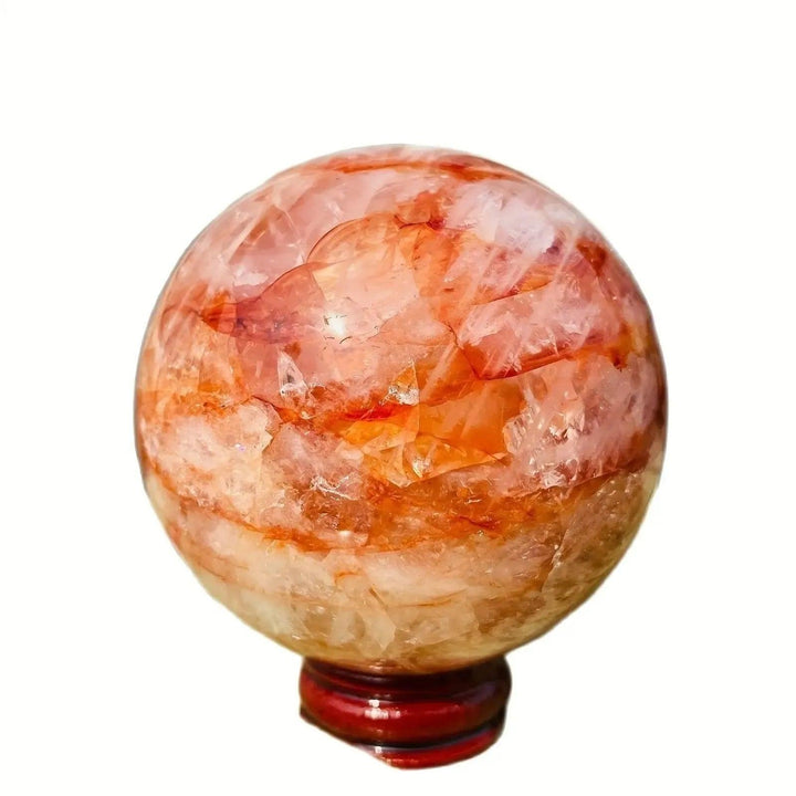 Polished Fire Quartz Hematoid Sphere from Crystal Destiny, featuring fiery red-orange inclusions and a wooden stand.