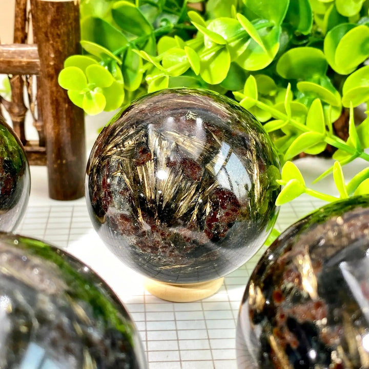 Black Firework Jasper crystal sphere from Crystal Destiny, showcasing golden bursts and earthy tones.