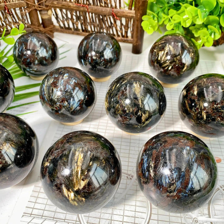 Crystal Destiny's Firework Jasper spheres with dark, reflective surfaces and vibrant golden-brown bursts.