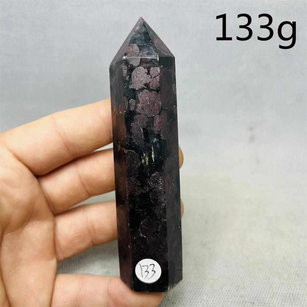 Fireworks Garnet Tower featuring vibrant red crystals in a polished stone point for root chakra grounding and vitality.
