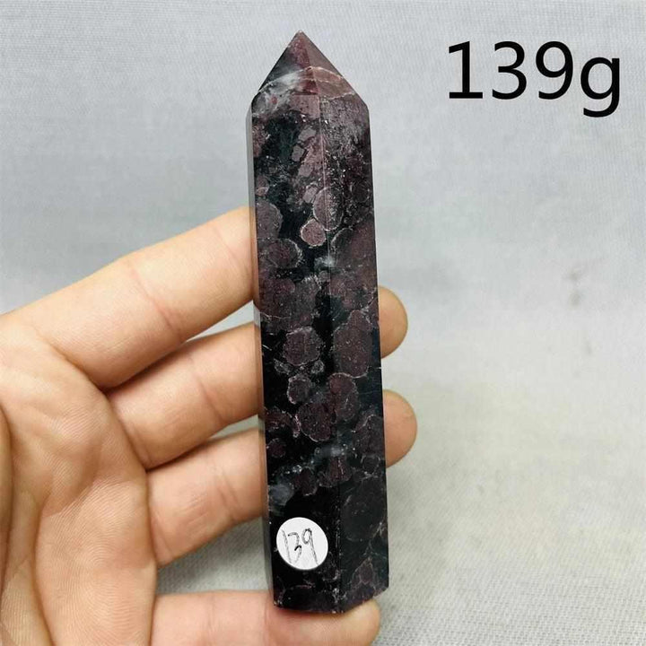 Fireworks Garnet Tower featuring vibrant red crystals in a polished stone matrix for grounding root chakra energy.