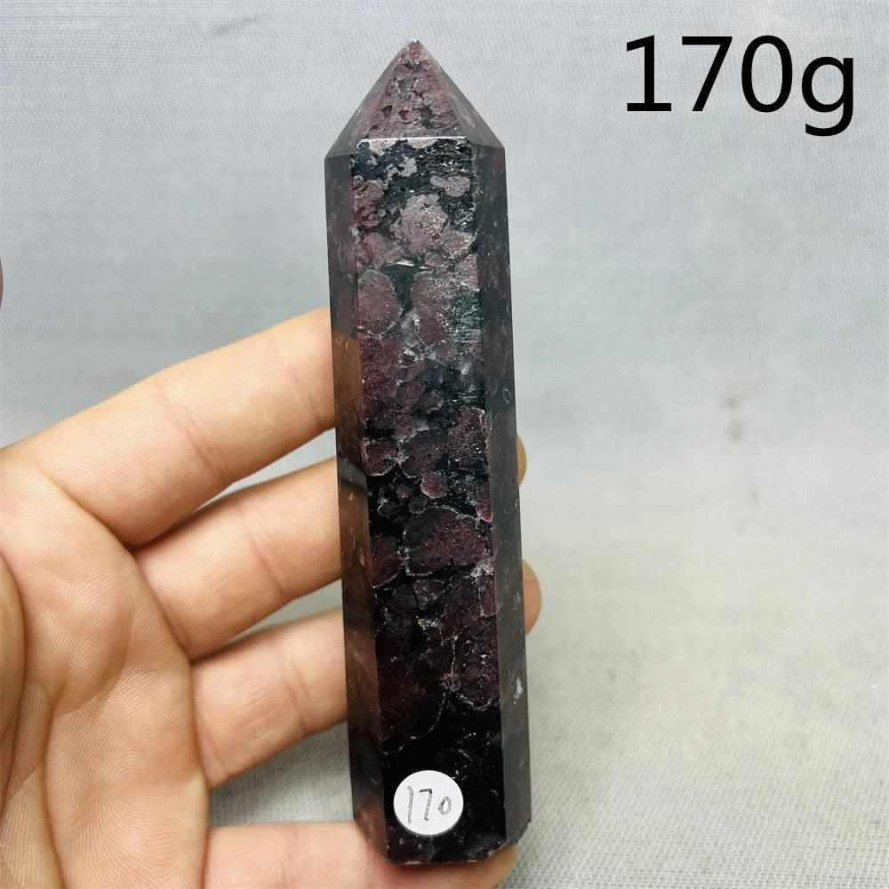 Fireworks Garnet Tower featuring deep red crystals in a polished stone point for grounding root chakra energy.