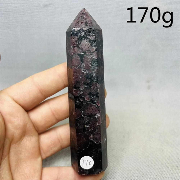 Fireworks Garnet Tower featuring deep red crystals in a polished stone point for grounding root chakra energy.