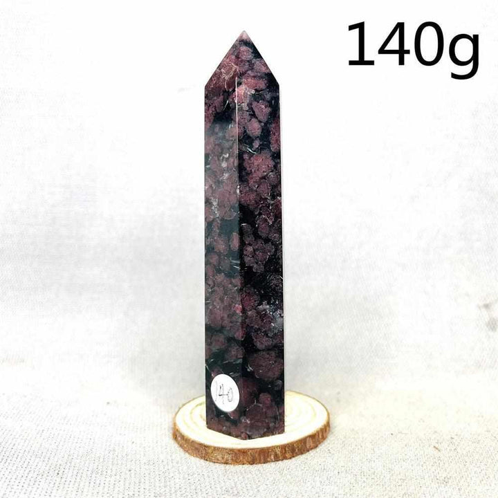 Polished Fireworks Garnet tower featuring deep red crystals in a dark matrix for grounding energy and vitality.