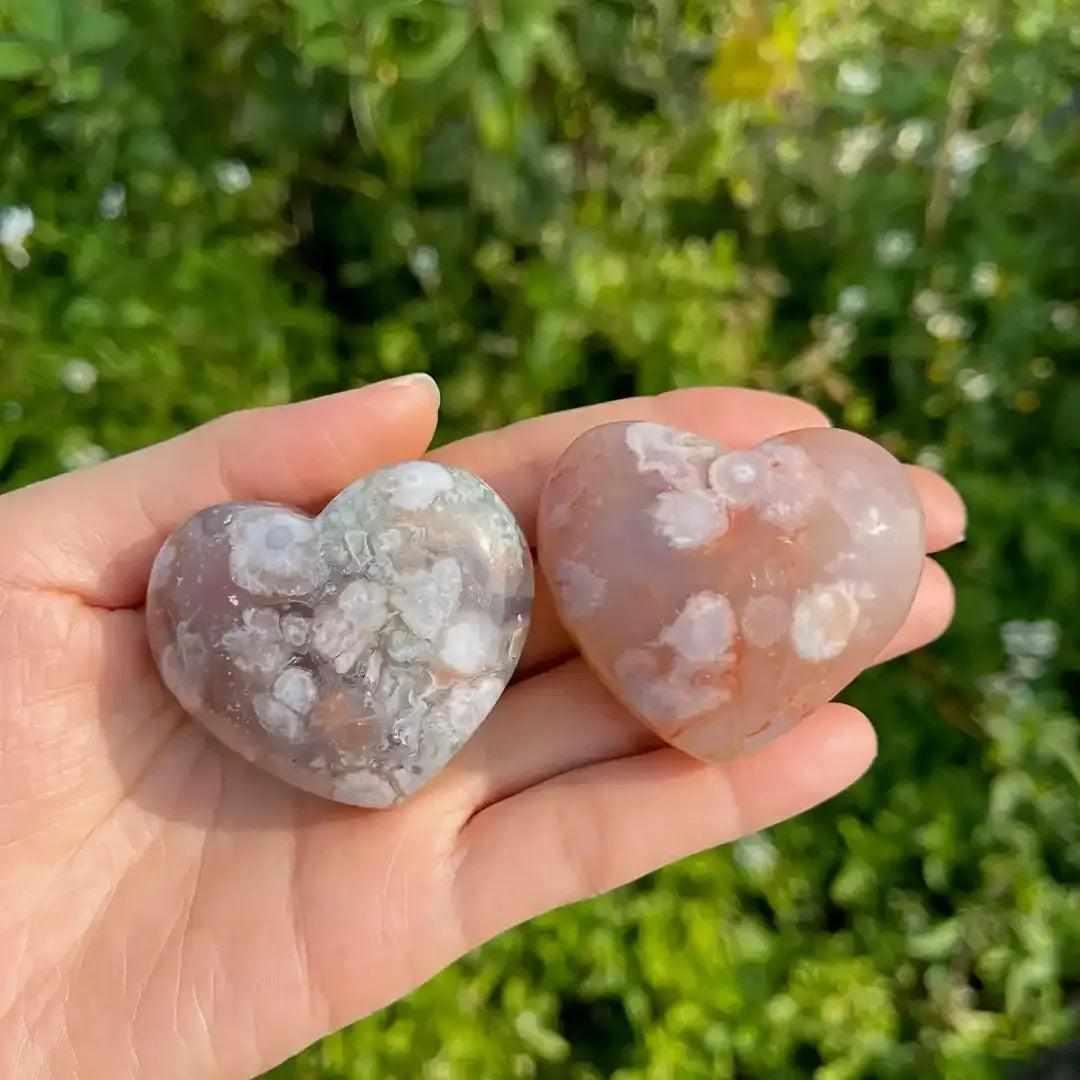 Two polished Flower Agate hearts with pink and white blossom plumes, perfect for Heart Chakra healing and self-love.