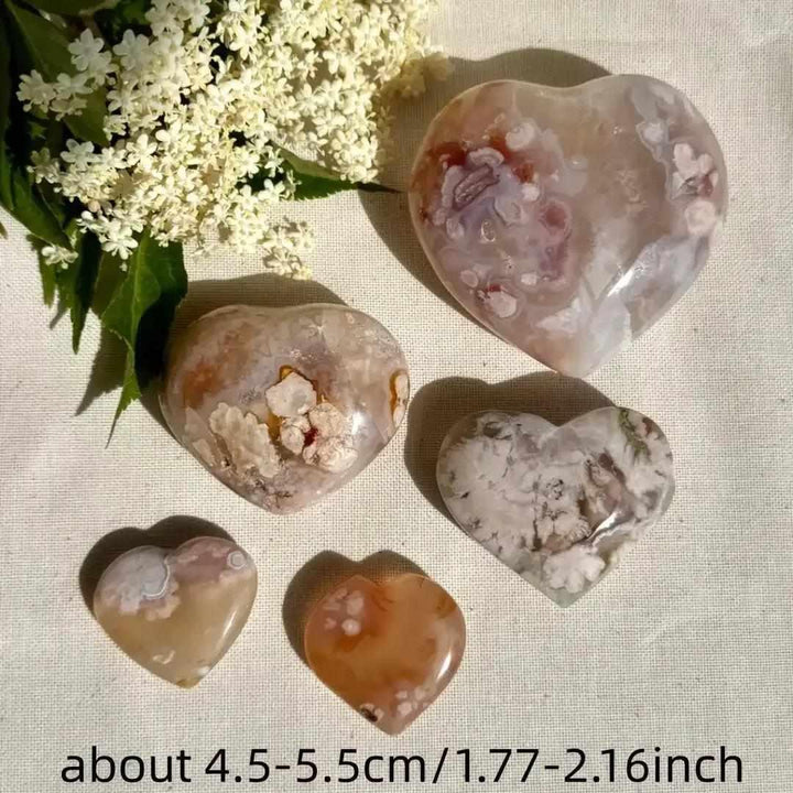 Polished Flower Agate hearts featuring pink and white blossom plumes for Heart Chakra healing and emotional renewal.