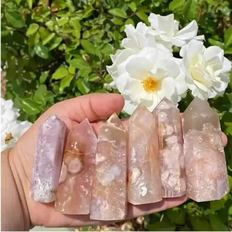 Handheld Flower Agate tower featuring soft pink and white blossom plumes for Heart Chakra healing and emotional renewal.