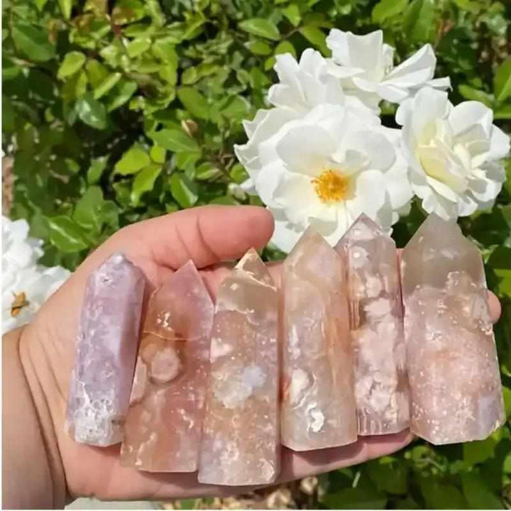 Handheld Flower Agate tower featuring soft pink and white blossom plumes for Heart Chakra healing and emotional renewal.