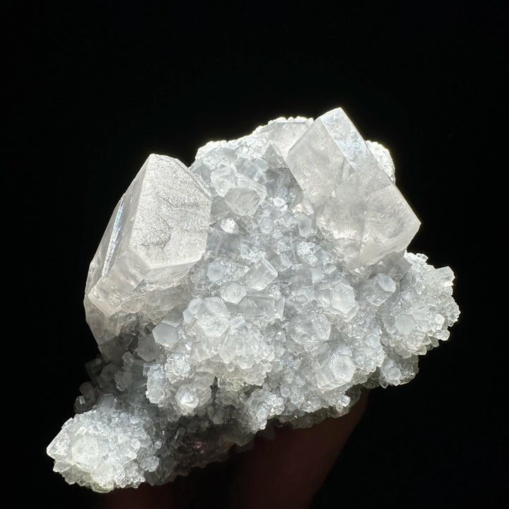 Sparkling raw columnar calcite crystal cluster, a highly transparent healing stone specimen.