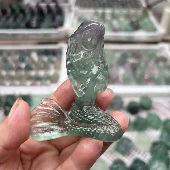 Hand-carved natural fluorite mermaid crystal figurine with purple and green hues, perfect for healing and home decor.