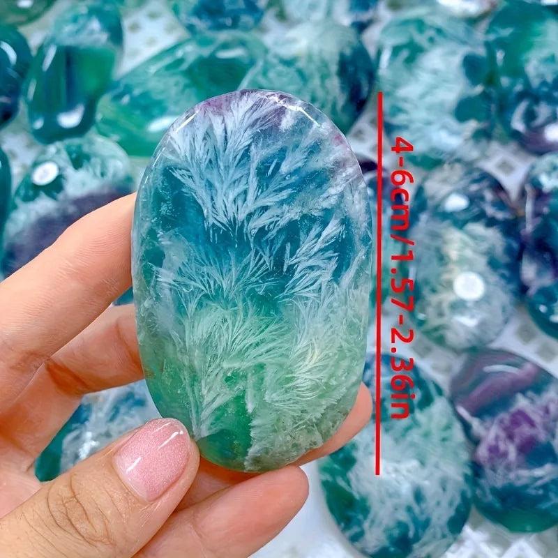 Polished feather snowflake fluorite palm stone with vibrant purple and green hues, 4-6cm healing crystal for meditation.