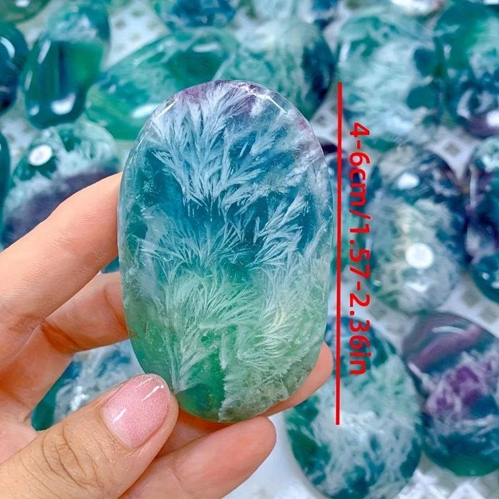 Polished feather snowflake fluorite palm stone with vibrant purple and green hues, 4-6cm healing crystal for meditation.