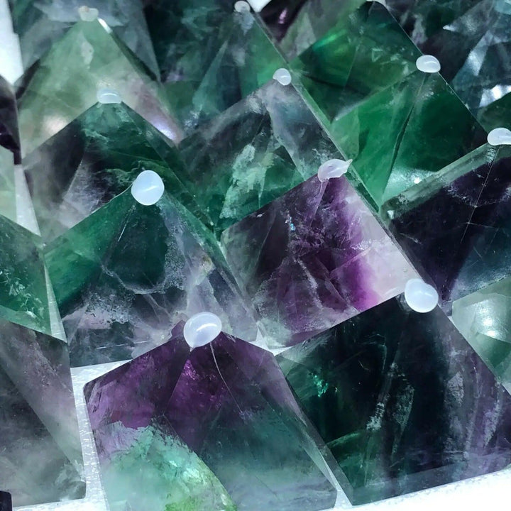Vibrant Fluorite Crystal Pyramids in green, purple, and teal, promoting focus and calm.