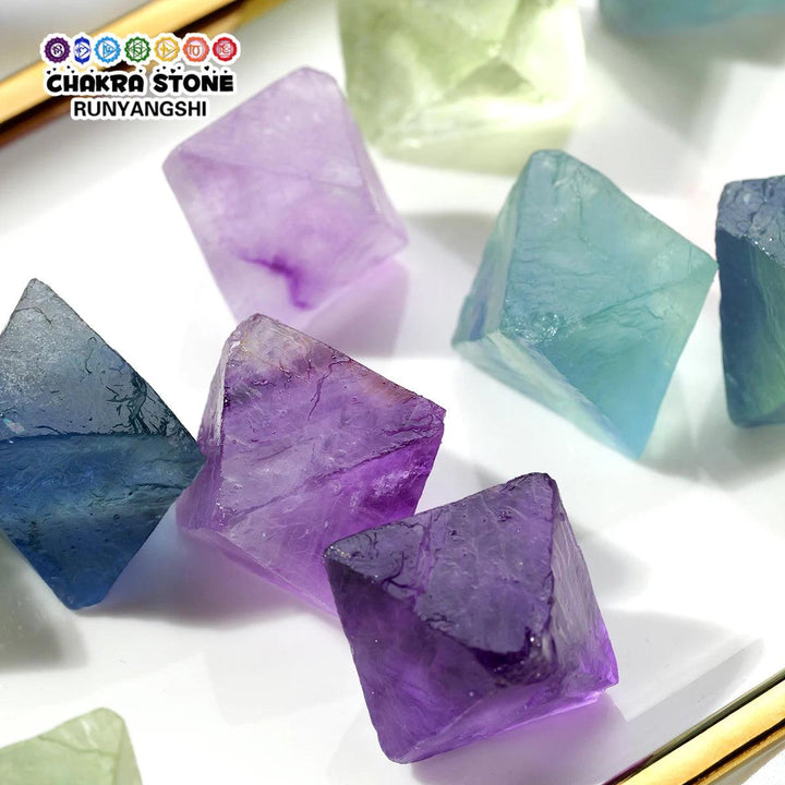 Raw Fluorite Crystal Octahedron stones in deep violet, seafoam green, and cool blue hues, perfect for focus and healing.