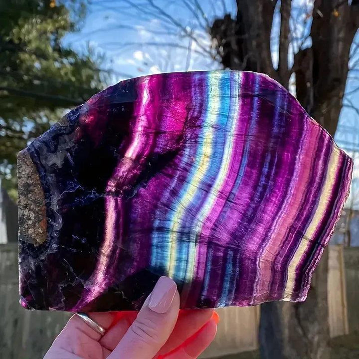 Vibrant Fluorite Crystal Slice: natural rainbow stone with purple, green, and teal bands for mental clarity and focus.