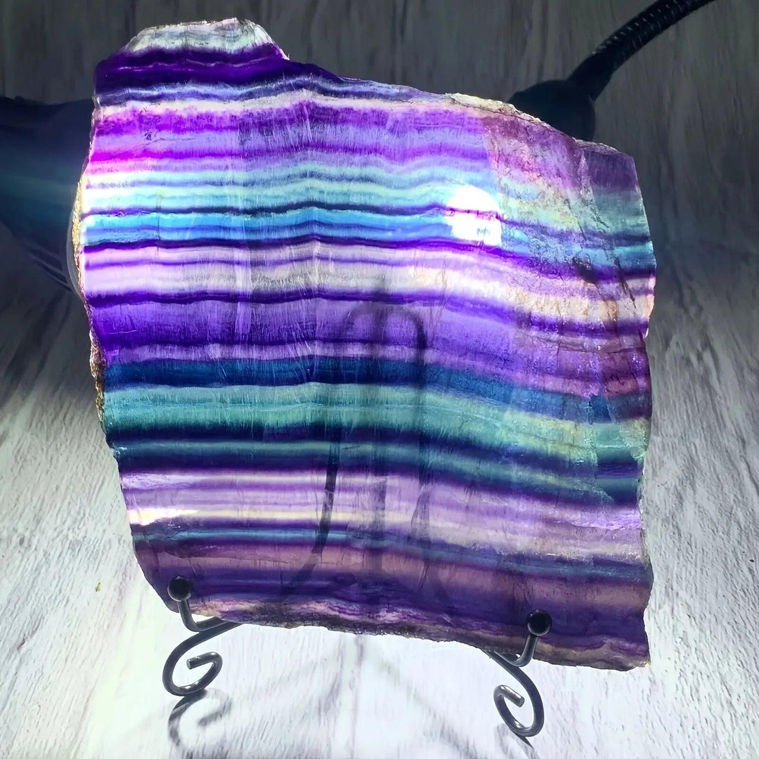 Vibrant Fluorite Crystal Slice from Crystal Destiny, displaying striking purple, green, and blue color bands for clarity and focus.